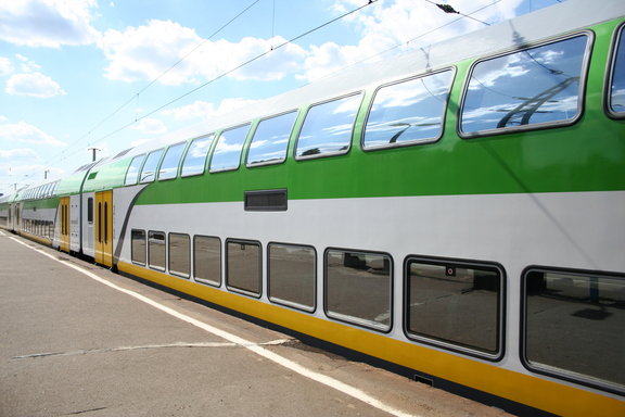 pociąg w biało zielono żółtych barwach mazowieckiego przewoźnika