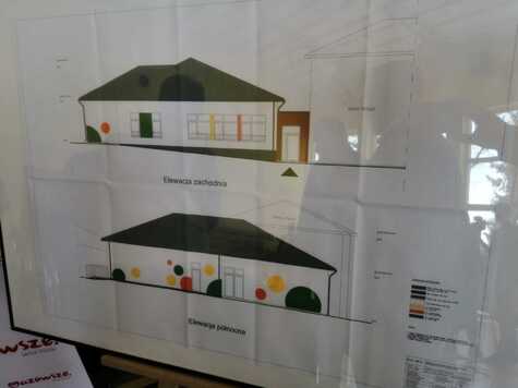 Plansza z narysowanymi dwoma rzutami bocznymi budynku nowej szkoły